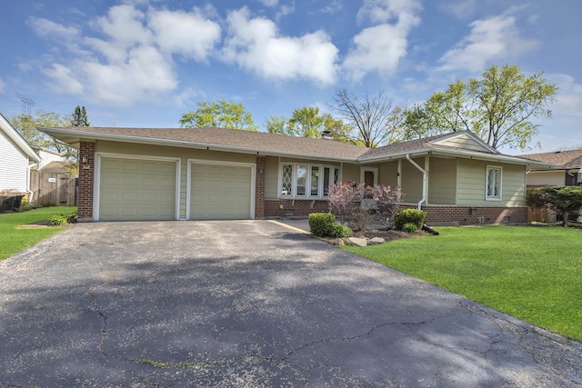 ranch-style home with brick siding, an attached garage, asphalt driveway, and a front yard