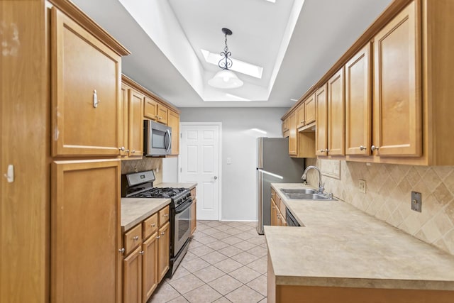 kitchen featuring stainless steel appliances, a skylight, a sink, backsplash, and light tile patterned floors