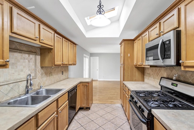 kitchen with gas range, stainless steel microwave, a sink, dishwasher, and a skylight