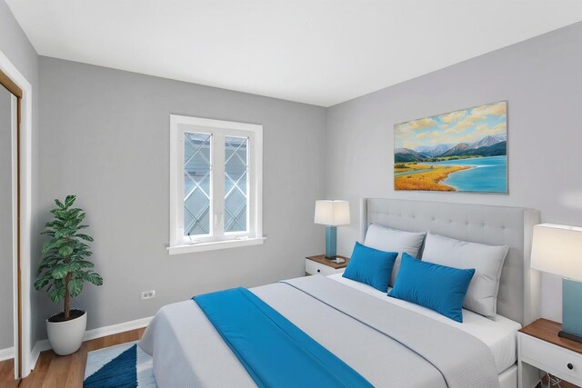 bedroom with wood finished floors and baseboards
