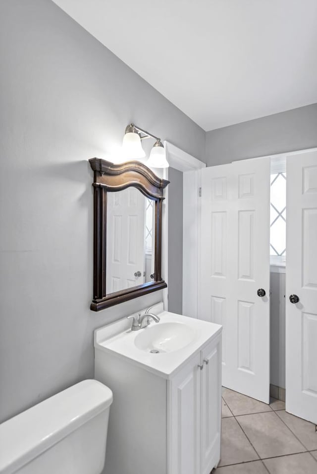 bathroom featuring toilet, tile patterned floors, and vanity