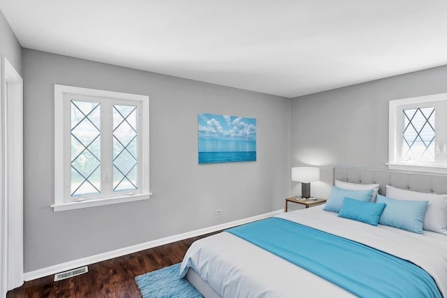 bedroom with wood finished floors and baseboards