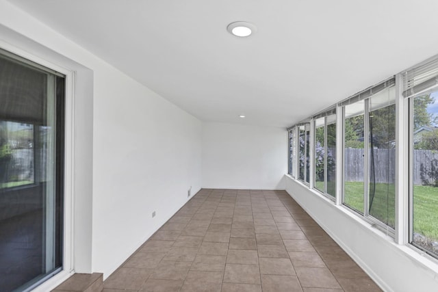 unfurnished sunroom with tile patterned flooring