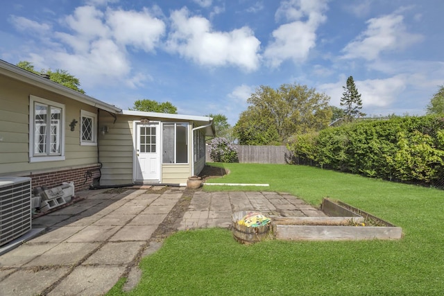 view of yard featuring a patio, central air condition unit, and a vegetable garden