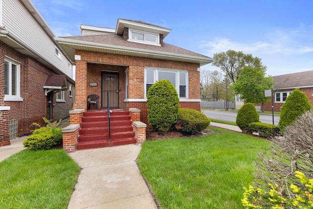7559 S Michigan Ave, Chicago, IL 60619 - view of front of house with brick siding, a front yard, and roof with shingles