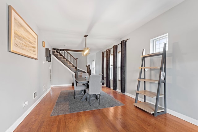 7559 S Michigan Ave, Chicago, IL 60619 - unfurnished dining area with stairway, wood finished floors, and baseboards