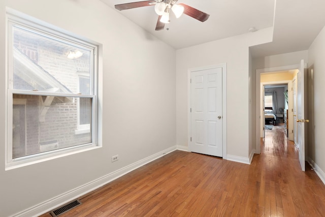 7559 S Michigan Ave, Chicago, IL 60619 - unfurnished bedroom with wood finished floors, baseboards, and ceiling fan