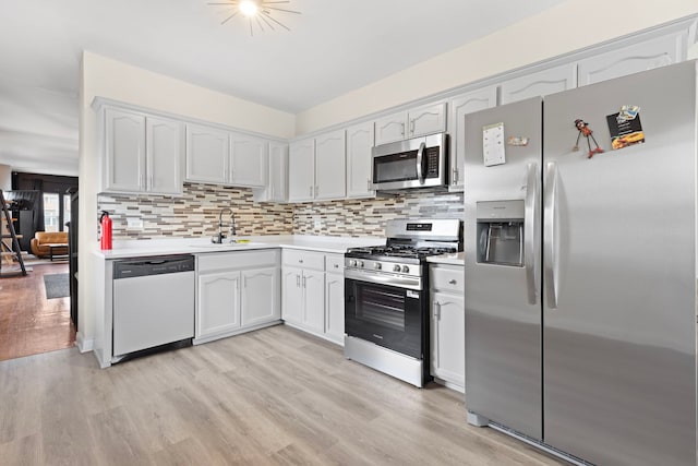 7559 S Michigan Ave, Chicago, IL 60619 - kitchen with stainless steel appliances, a sink, light countertops, and light wood-type flooring
