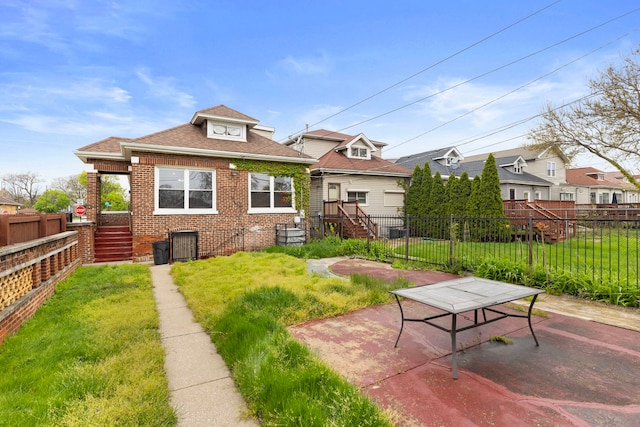 7559 S Michigan Ave, Chicago, IL 60619 - back of house featuring brick siding, stairs, a shingled roof, and a patio