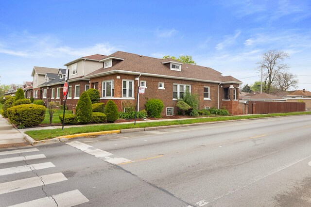 7559 S Michigan Ave, Chicago, IL 60619 - view of side of property featuring brick siding and roof with shingles
