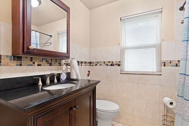 7559 S Michigan Ave, Chicago, IL 60619 - full bath with vanity, toilet, tile walls, curtained shower, and a wainscoted wall
