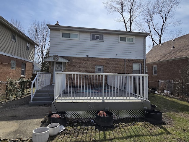 40 166th Pl, Calumet City, IL 60409 - rear view of property with a wooden deck, fence, brick siding, and a chimney