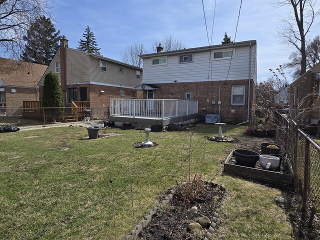 40 166th Pl, Calumet City, IL 60409 - rear view of house with brick siding, a lawn, a wooden deck, and a fenced backyard