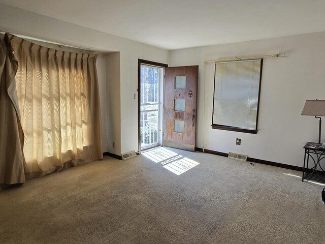 40 166th Pl, Calumet City, IL 60409 - spare room featuring visible vents, baseboards, and carpet