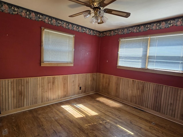 40 166th Pl, Calumet City, IL 60409 - unfurnished room featuring visible vents, a ceiling fan, wood finished floors, and wainscoting