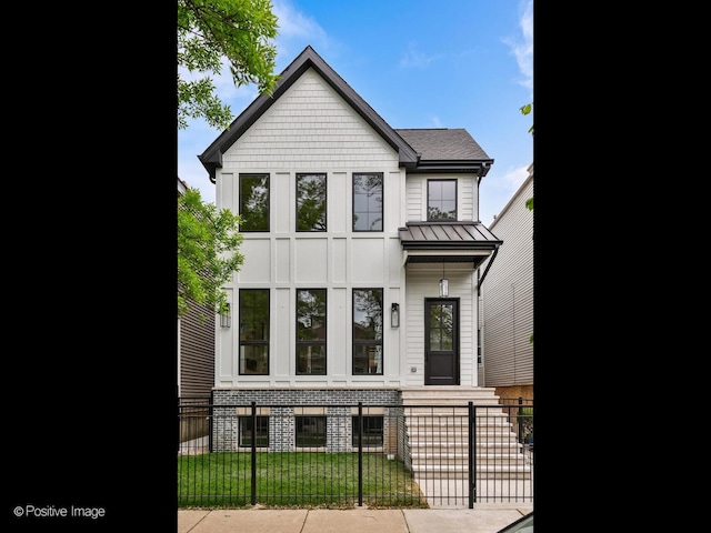 2141 W Grace St, Chicago, IL 60618 - view of front facade with a fenced front yard, a standing seam roof, and a metal roof