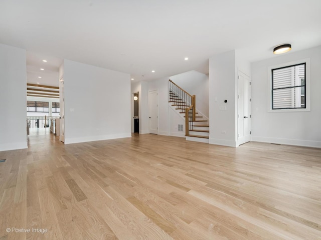 2141 W Grace St, Chicago, IL 60618 - unfurnished living room with light wood finished floors, stairway, and recessed lighting