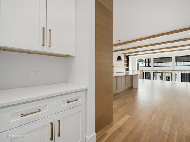 2141 W Grace St, Chicago, IL 60618 - kitchen featuring light wood-type flooring, white cabinetry, light stone counters, beam ceiling, and recessed lighting