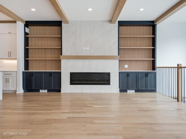 2141 W Grace St, Chicago, IL 60618 - unfurnished living room with beam ceiling, wood finished floors, a large fireplace, recessed lighting, and built in shelves