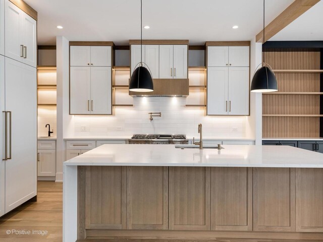 2141 W Grace St, Chicago, IL 60618 - kitchen with tasteful backsplash, light wood finished floors, range, pendant lighting, and recessed lighting