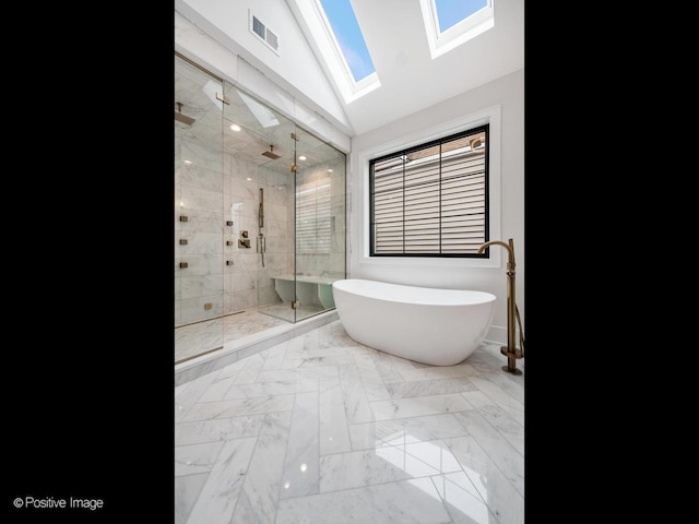 2141 W Grace St, Chicago, IL 60618 - full bathroom featuring a stall shower, a freestanding bath, a skylight, vaulted ceiling, and marble finish floors