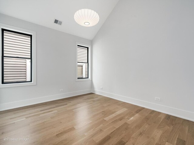 2141 W Grace St, Chicago, IL 60618 - empty room featuring light wood-type flooring and high vaulted ceiling