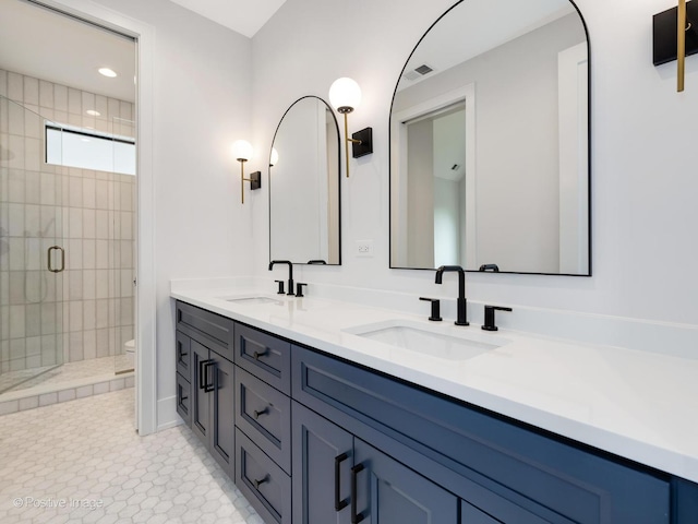 2141 W Grace St, Chicago, IL 60618 - full bathroom with double vanity, a shower stall, and recessed lighting