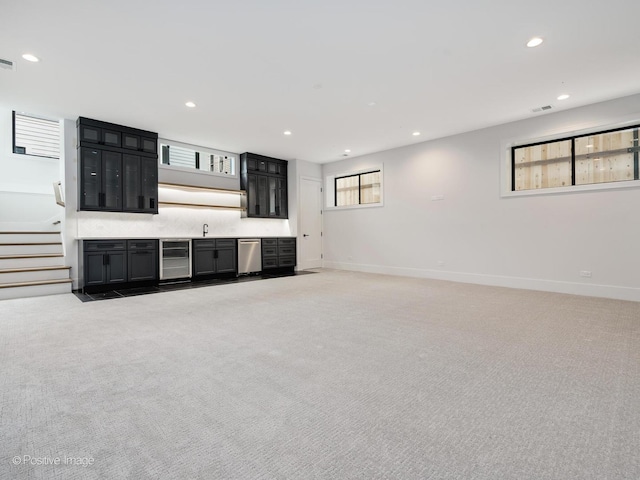 2141 W Grace St, Chicago, IL 60618 - unfurnished living room featuring light colored carpet, wine cooler, and recessed lighting