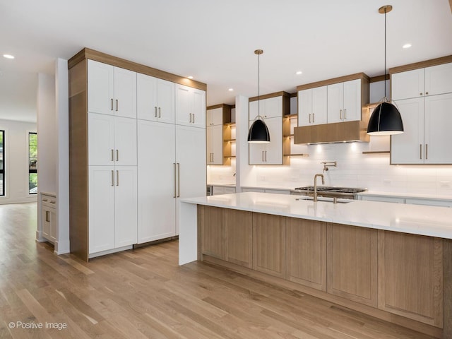 2141 W Grace St, Chicago, IL 60618 - kitchen with light wood finished floors, backsplash, light countertops, and recessed lighting