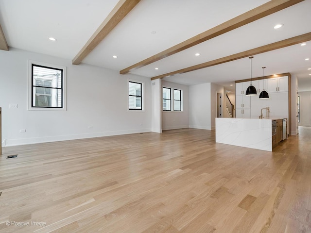 2141 W Grace St, Chicago, IL 60618 - unfurnished living room featuring beamed ceiling, light wood-type flooring, stairs, and recessed lighting
