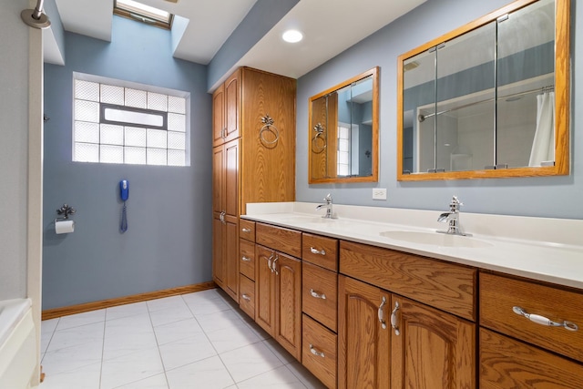 bathroom with double vanity, baseboards, a sink, and a shower with curtain