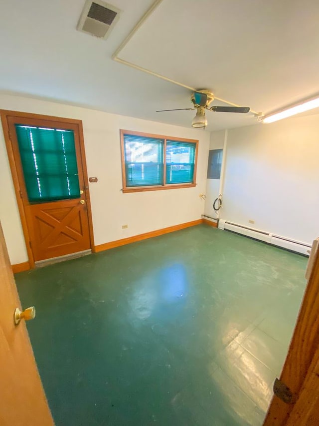 spare room featuring baseboard heating, baseboards, a ceiling fan, and visible vents