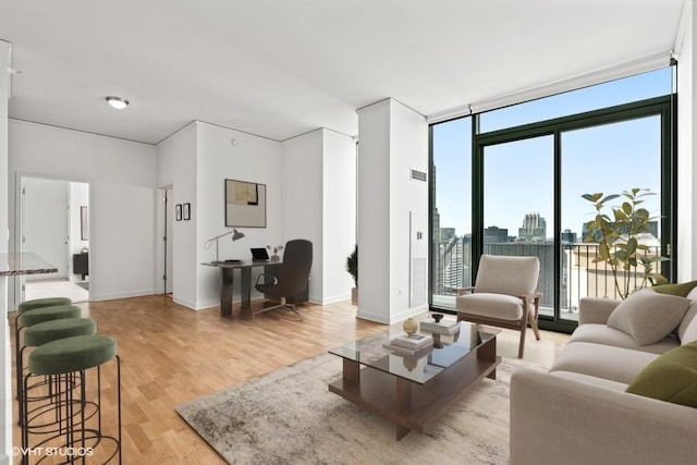 225 N Columbus Dr Unit 5703, Chicago, IL 60601 - living area with floor to ceiling windows, light wood-type flooring, a desk, baseboards, and a skyline view