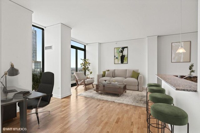 225 N Columbus Dr Unit 5703, Chicago, IL 60601 - living area featuring floor to ceiling windows, light wood-type flooring, and an office area