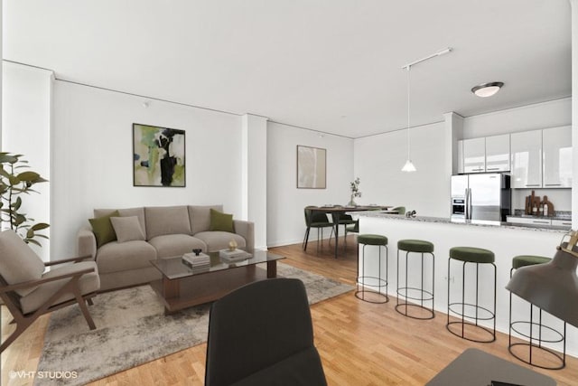 225 N Columbus Dr Unit 5703, Chicago, IL 60601 - living area featuring light wood-style floors and rail lighting