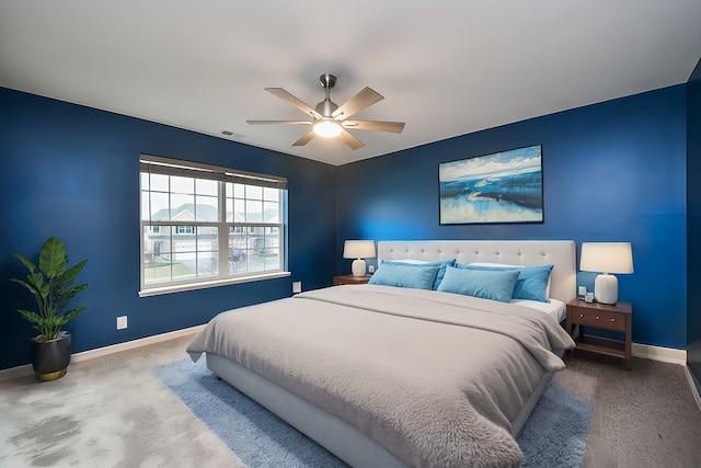 carpeted bedroom featuring visible vents, baseboards, and a ceiling fan