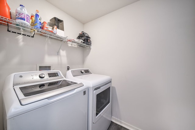 laundry area featuring washer and clothes dryer, laundry area, and baseboards