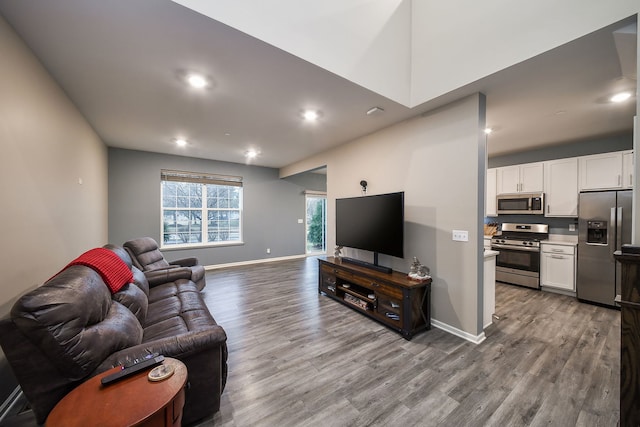 living room featuring recessed lighting, wood finished floors, and baseboards