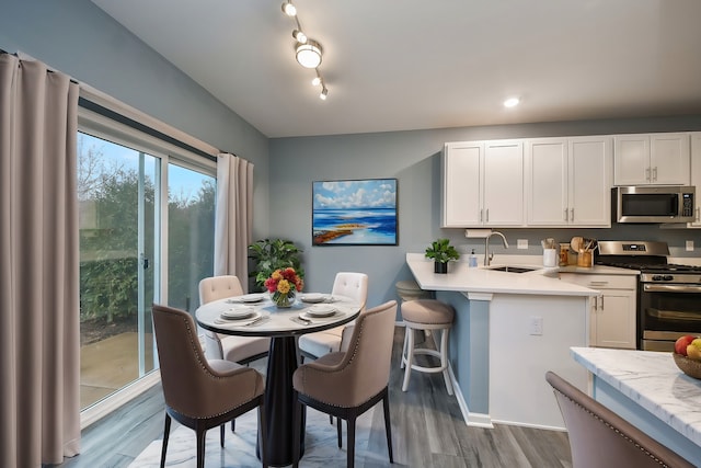 dining area featuring baseboards and wood finished floors