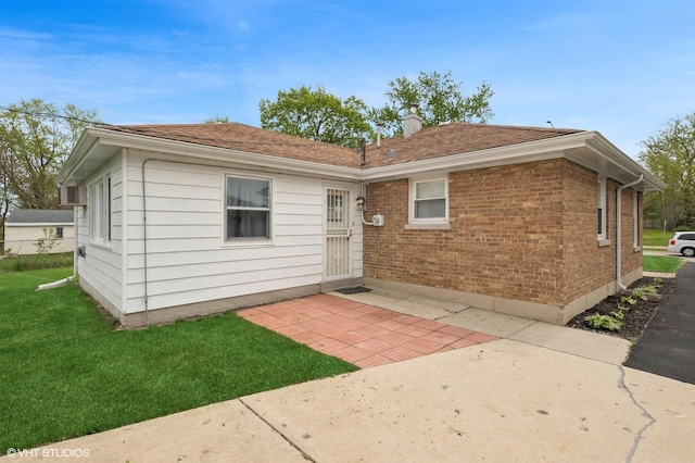 236 Indianwood Blvd, Park Forest, IL 60466 - rear view of house featuring a wall mounted AC, roof with shingles, and a yard