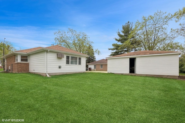 236 Indianwood Blvd, Park Forest, IL 60466 - rear view of property with an outbuilding, roof with shingles, a wall unit AC, and a yard