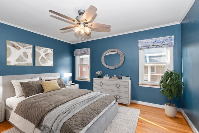 bedroom featuring multiple windows, baseboards, and wood finished floors