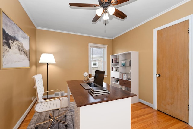 home office with ornamental molding, ceiling fan, light wood-style floors, and baseboards