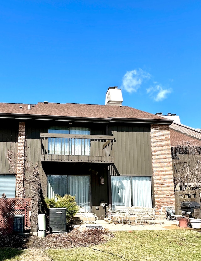 1927 Mission Hills Ln, Northbrook, IL 60062 - back of house featuring a balcony, a patio, a chimney, and central AC