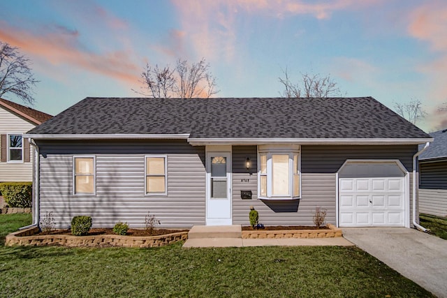 view of front of home featuring a garage, roof with shingles, concrete driveway, and a front yard