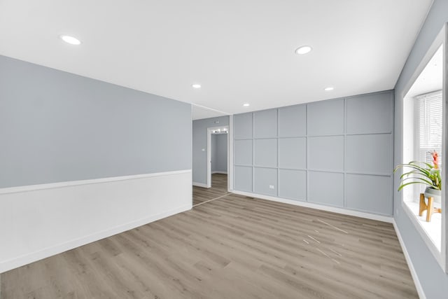 unfurnished room featuring recessed lighting, baseboards, and wood finished floors