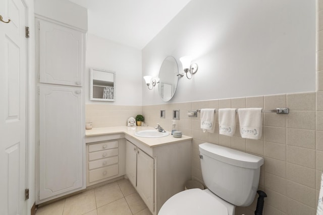 4221 Saratoga Ave Unit 310-A, Downers Grove, IL 60515 - bathroom with a wainscoted wall, toilet, vanity, tile patterned flooring, and tile walls