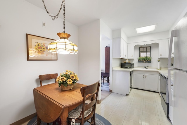 4221 Saratoga Ave Unit 310-A, Downers Grove, IL 60515 - dining space with a skylight and light floors