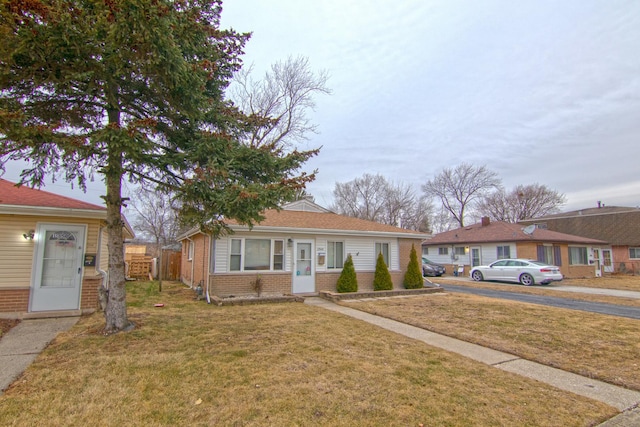1344 Superior Ave, Calumet City, IL 60409 - view of front of house with brick siding, a front lawn, and fence