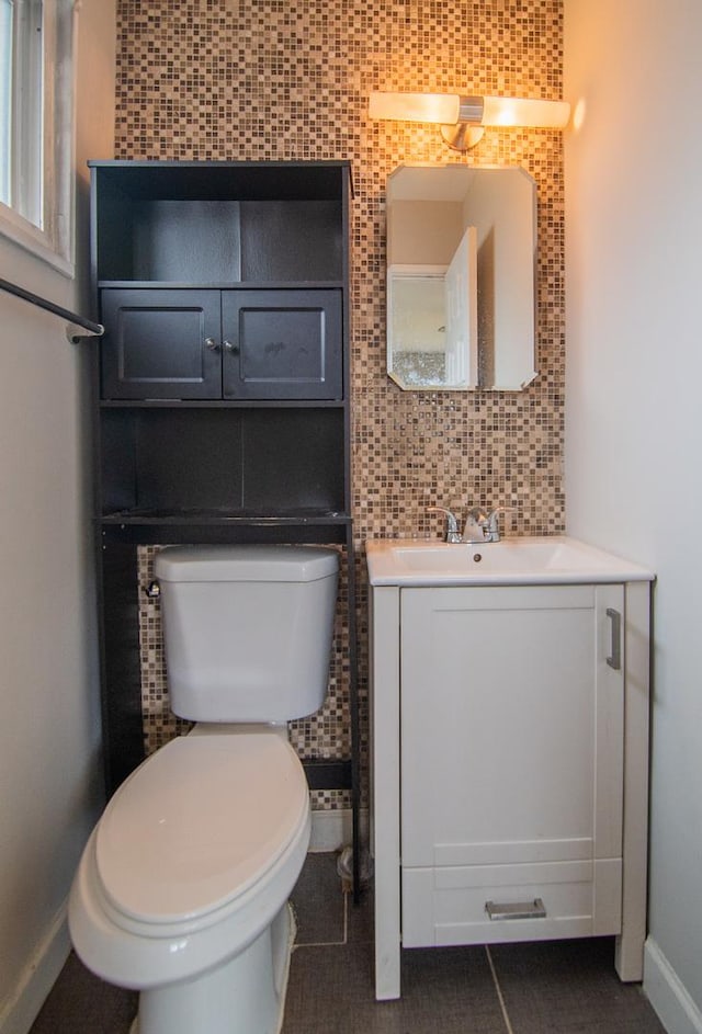 1344 Superior Ave, Calumet City, IL 60409 - bathroom featuring tile walls, baseboards, toilet, decorative backsplash, and vanity